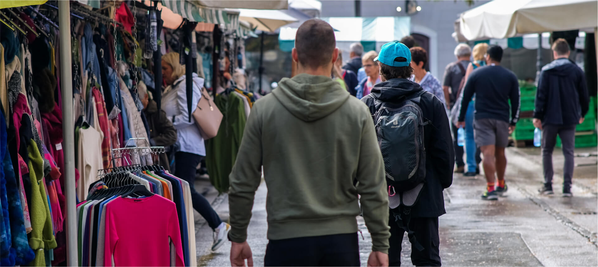 Individual walking confidently in an urban setting while observing his environment, demonstrating situational awareness.